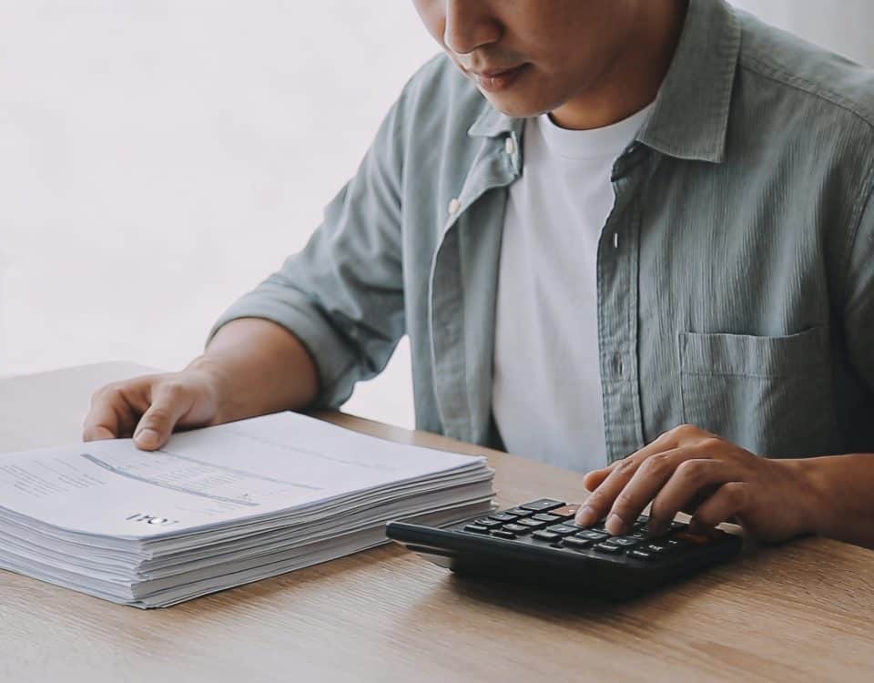 homme assis au bureau calculant interets de pret